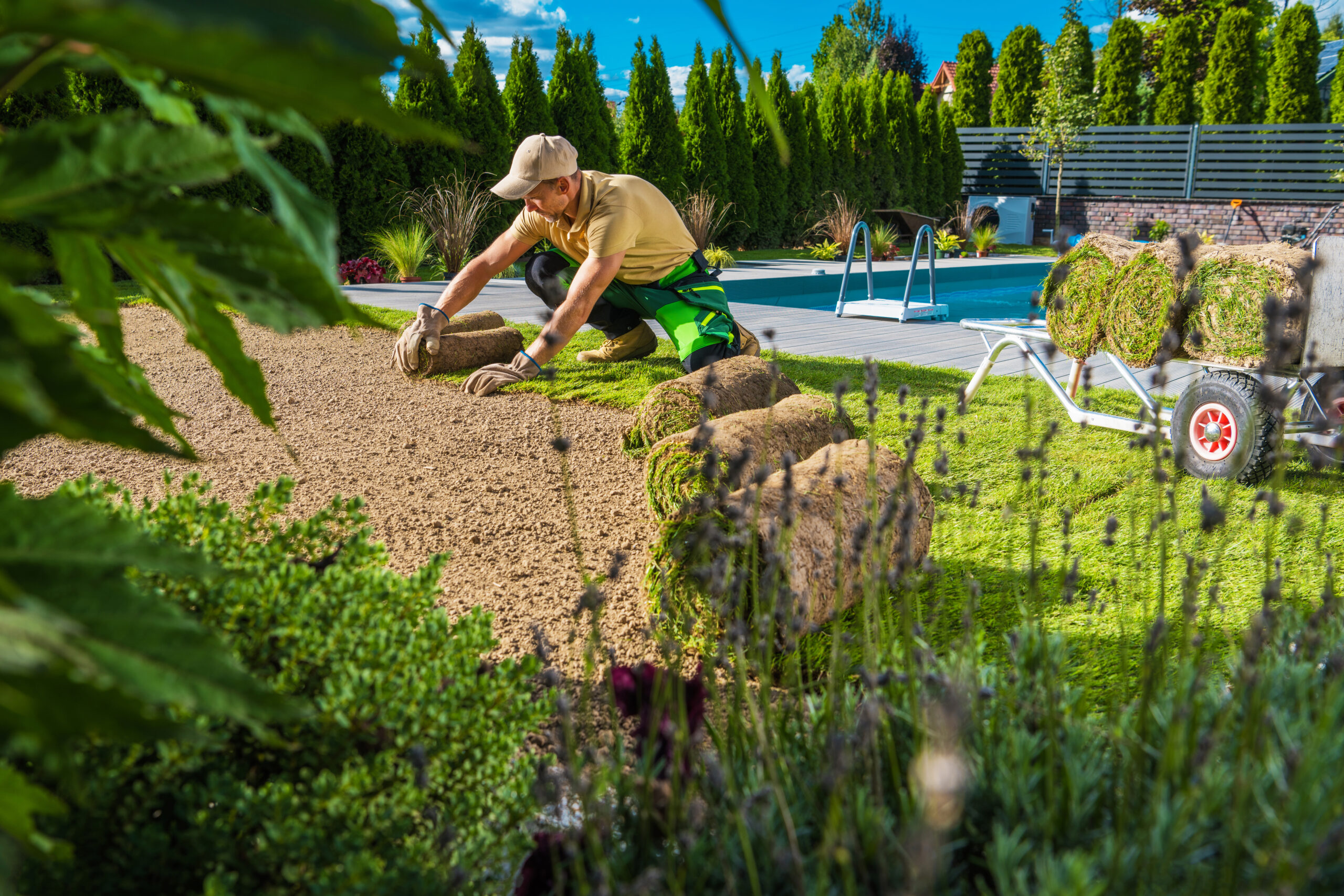 landscaper fixing a lawn while also learning about the benefits of SEO for landscapers